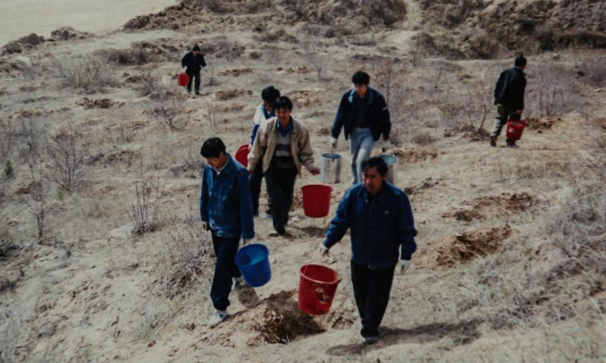 90年代準能集團職工為樹苗澆水。