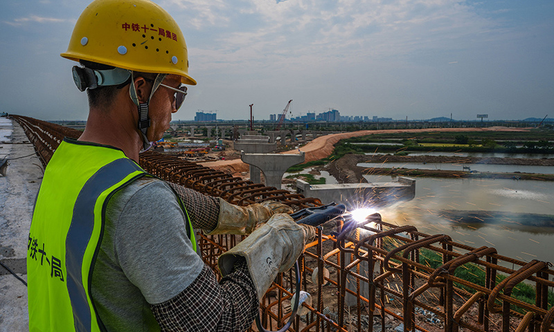 圖為5月1日，工人在珠海鶴港高速公路二期工程高欄港樞紐立交橋建設現場焊接鋼筋。（新華社記者 劉大偉 攝）